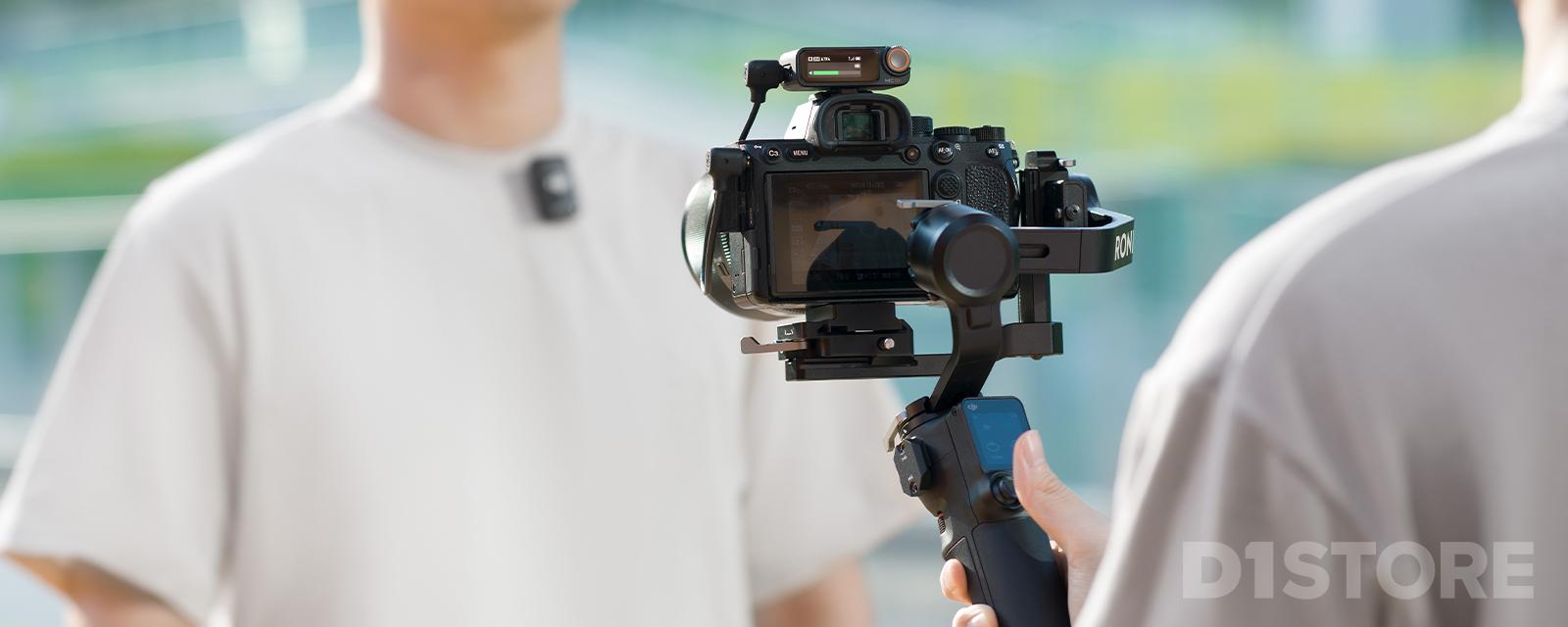 Man filming with camera mounted with DJI Ronin gimbal and DJI Mic 2