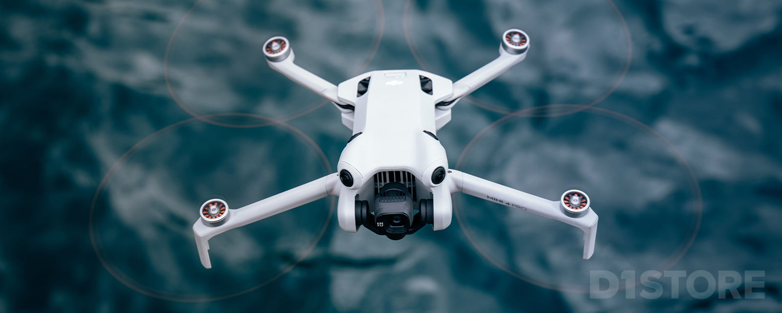 DJI Mini 4 Pro drone in flight over ocean